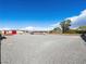 Wide-open property featuring clear, blue skies, and a large, graveled area at 5340 N Campbell Rd, Las Vegas, NV 89149