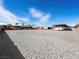 Expansive gravel lot with outbuildings and a clear, blue sky at 5340 N Campbell Rd, Las Vegas, NV 89149