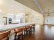 Bright kitchen and bar area with white cabinets, stainless appliances, and a long quartz countertop at 5340 N Campbell Rd, Las Vegas, NV 89149