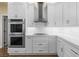 Modern kitchen features sleek, white cabinetry, stainless steel appliances, and bright lighting at 5340 N Campbell Rd, Las Vegas, NV 89149