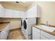 Bright laundry room with washer, dryer, white cabinets and countertops at 5340 N Campbell Rd, Las Vegas, NV 89149
