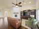 Bright living room features a painted brick fireplace, ceiling fan, hardwood floors and built-in shelving unit at 5340 N Campbell Rd, Las Vegas, NV 89149