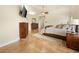 A bedroom with a ceiling fan, tile floors, and wooden furniture at 5340 N Campbell Rd, Las Vegas, NV 89149