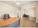 Home office with a desk, tile floors, baseboard trim, and mirrored closet doors at 5340 N Campbell Rd, Las Vegas, NV 89149