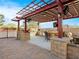Fully equipped covered outdoor kitchen with bar and various cooking appliances; an entertainer's dream at 5340 N Campbell Rd, Las Vegas, NV 89149