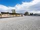 Large, gravel parking area with metal awning and potential space for vehicle storage and outdoor activities at 5340 N Campbell Rd, Las Vegas, NV 89149