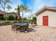 Cozy outdoor patio featuring a dining set, landscaping and access to the main house at 5340 N Campbell Rd, Las Vegas, NV 89149