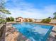 Beautiful backyard pool with in-pool seating, a patio area, and lush landscaping at 5340 N Campbell Rd, Las Vegas, NV 89149