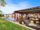 Outdoor kitchen and covered pergola next to the swimming pool with sun loungers at 5340 N Campbell Rd, Las Vegas, NV 89149