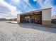 Exterior of a metal shed with open bay and shelves, surrounded by gravel and a bright blue sky at 5340 N Campbell Rd, Las Vegas, NV 89149