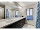 Bathroom with double sinks, granite countertops, and a shower-tub combo at 6618 Tangled Vines Ave, Las Vegas, NV 89139