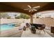 Relaxing outdoor covered patio with stylish wicker furniture overlooking the sparkling pool at 6709 Rancho Santa Fe Dr, Las Vegas, NV 89130