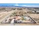 Expansive aerial view of a desert landscape, including a large estate with a pool and outbuildings at 671 W Hickory St, Pahrump, NV 89048