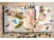 Expansive aerial shot shows a home with a large lot featuring a pool, and mature landscaping and a long driveway at 671 W Hickory St, Pahrump, NV 89048