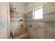 Shower with a built-in bench, rainfall shower head, and attractive tile work at 671 W Hickory St, Pahrump, NV 89048