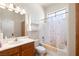 Well-lit bathroom with a vanity, toilet, and shower-tub combination with butterfly shower curtain at 671 W Hickory St, Pahrump, NV 89048