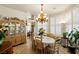 Elegant dining room with a large chandelier, and natural light, ideal for Gathering gatherings and formal dining at 671 W Hickory St, Pahrump, NV 89048