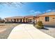 Spacious home featuring a long driveway and desert landscaping, enhancing curb appeal and offering ample parking at 671 W Hickory St, Pahrump, NV 89048