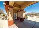 Covered front entry featuring well-manicured landscaping and a welcoming atmosphere at 671 W Hickory St, Pahrump, NV 89048