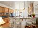 Bright kitchen featuring custom cabinetry, a breakfast bar with pendant lighting, and stainless steel appliances at 671 W Hickory St, Pahrump, NV 89048