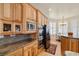 Well-appointed kitchen featuring wooden cabinets, granite countertops, and stainless steel appliances perfect for cooking enthusiasts at 671 W Hickory St, Pahrump, NV 89048