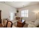 Comfortable living room area features shutters, wood furniture and neutral carpet at 671 W Hickory St, Pahrump, NV 89048