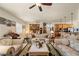 Spacious living room featuring comfortable seating, a ceiling fan, and a view into the kitchen area at 671 W Hickory St, Pahrump, NV 89048