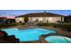 Backyard featuring a large pool and spa, set in a well-maintained yard, ideal for outdoor relaxation and entertaining at 671 W Hickory St, Pahrump, NV 89048