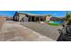 Large backyard with desert landscaping leading to a sparkling pool, spa, and covered patio, great for entertaining at 7119 Falabella Ridge Ave, Las Vegas, NV 89131