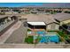 A luxurious backyard featuring a pool, in-ground spa, artificial grass, fire pit, and privacy fence at 7119 Falabella Ridge Ave, Las Vegas, NV 89131