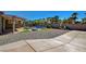 Expansive backyard featuring a pool with spa, covered patio, and low-maintenance desert landscaping at 7119 Falabella Ridge Ave, Las Vegas, NV 89131