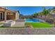 Well-manicured backyard showcasing a pool and spa, a fire pit, and easy-care desert landscaping at 7119 Falabella Ridge Ave, Las Vegas, NV 89131