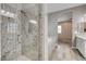 Bathroom featuring a glass-enclosed shower, soaking tub, and vanity with granite counters at 7119 Falabella Ridge Ave, Las Vegas, NV 89131
