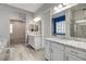 Bathroom showcasing granite counters, walk-in shower, and vanity with double sinks, adjacent to main bedroom at 7119 Falabella Ridge Ave, Las Vegas, NV 89131