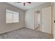 Bedroom with neutral walls, carpet, ceiling fan and a window with blinds and a doorway to another room at 7119 Falabella Ridge Ave, Las Vegas, NV 89131