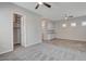 A sizable bedroom showcasing a walk-in closet and a wet bar, with gray carpet and natural light at 7119 Falabella Ridge Ave, Las Vegas, NV 89131