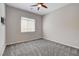 A carpeted bedroom with a ceiling fan and window provides a quiet and comfortable retreat at 7119 Falabella Ridge Ave, Las Vegas, NV 89131