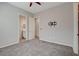 Bedroom featuring neutral walls, carpet, and doorways leading to a bathroom, closet, and hallway at 7119 Falabella Ridge Ave, Las Vegas, NV 89131