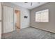 Bedroom with plush carpeting, ceiling fan, window, and a TV mount on the wall offers relaxation and entertainment at 7119 Falabella Ridge Ave, Las Vegas, NV 89131