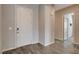 Welcoming home entryway featuring a stylish front door, neutral paint, and elegant wood-look tile flooring at 7119 Falabella Ridge Ave, Las Vegas, NV 89131