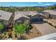 Charming desert home with mature landscaping, two car garage, brick driveway, and desert landscaping at 7119 Falabella Ridge Ave, Las Vegas, NV 89131