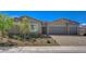 Beautiful single-story home featuring stone accents, desert landscaping, and a spacious three-car garage at 7119 Falabella Ridge Ave, Las Vegas, NV 89131