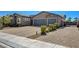 A charming residence featuring a well-maintained brick driveway, neatly trimmed shrubs, and a spacious three-car garage at 7119 Falabella Ridge Ave, Las Vegas, NV 89131