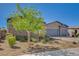 An elegant home with a stone facade, a manicured yard, and mature landscaping creating inviting curb appeal at 7119 Falabella Ridge Ave, Las Vegas, NV 89131