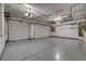 Spacious three car garage with epoxy floors, shelving, and overhead storage racks to maximize usable space at 7119 Falabella Ridge Ave, Las Vegas, NV 89131