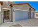 A spacious home featuring a two-car garage, stone accents, and brick-paved driveway for ample parking at 7119 Falabella Ridge Ave, Las Vegas, NV 89131