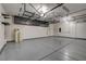 Large three car garage featuring epoxy flooring, overhead storage, and ample space for vehicles and equipment at 7119 Falabella Ridge Ave, Las Vegas, NV 89131