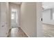 A hallway featuring hardwood flooring connects a bedroom and several closets at 7119 Falabella Ridge Ave, Las Vegas, NV 89131
