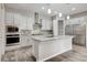 Modern kitchen featuring white cabinets, granite countertops, and stainless steel appliances at 7119 Falabella Ridge Ave, Las Vegas, NV 89131