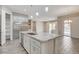 Open kitchen showcases granite counters, stainless steel appliances, island, and bright open floorplan at 7119 Falabella Ridge Ave, Las Vegas, NV 89131